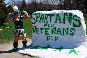 Sparty and the rock celebrating the Veterans Resource Center